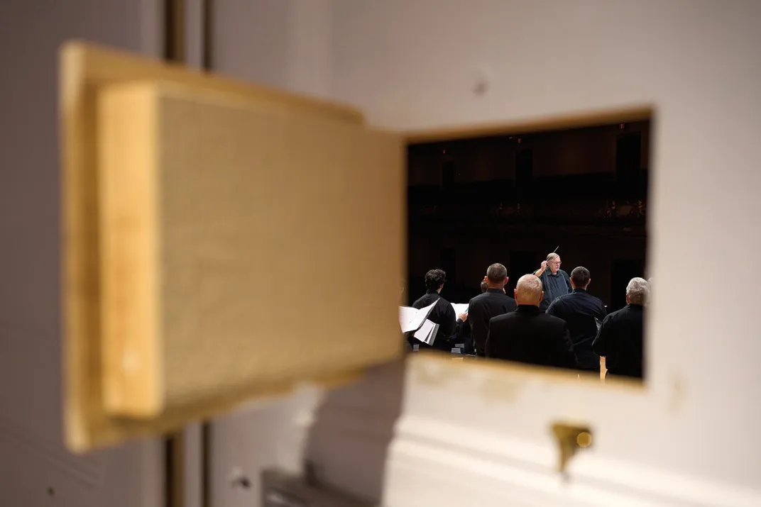 In a view from backstage at Boston’s Symphony Hall last October, David Hodgkins conducts pieces commissioned by the Terezin Music Foundation.