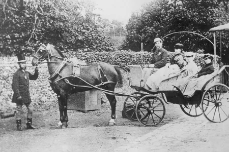 Author Charles Dickens (1812-1870) pictured with his wife, Catherine Dickens (1815-1879), and two of their daughters, seated in a horsedrawn carriage, circa 1850.
