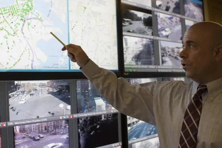 Traffic control centers like this one in Boston—a room cluttered with computer terminals and live video feeds of urban intersections—represent the brain of a traffic system. 