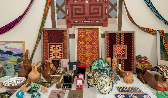 Several pieces of textiles, pottery, and other artwork arranged in an altar.