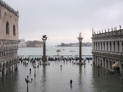 A general view shows the flooded St. Mark's Square, the Doge's Palace (L), the Lion of St. Mark winged bronze statue and the Venetian lagoon after an exceptional overnight "Alta Acqua" high tide water level, on November 13, 2019 in Venice. 