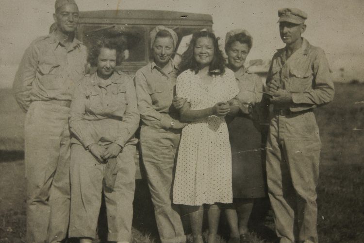 Josefina Guerrero and Americans stand in a field