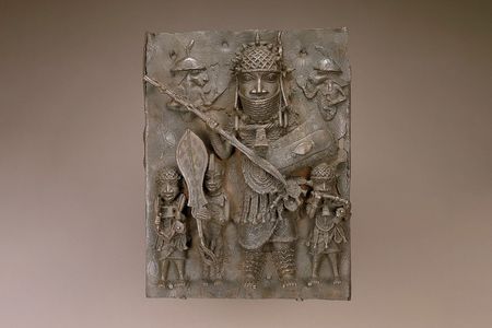 This 16th- or 17th-century copper alloy plaque&mdash;one of the ten Benin Bronzes removed from view&mdash;depicts a&nbsp;high-ranking warrior flanked by&nbsp;musicians and a page holding a ceremonial sword.