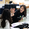 Woman with Smithsonian shirt gives girl a high five