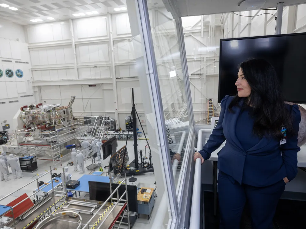 U.S. poet laureate Ada Limón watches the Europa Clipper being built