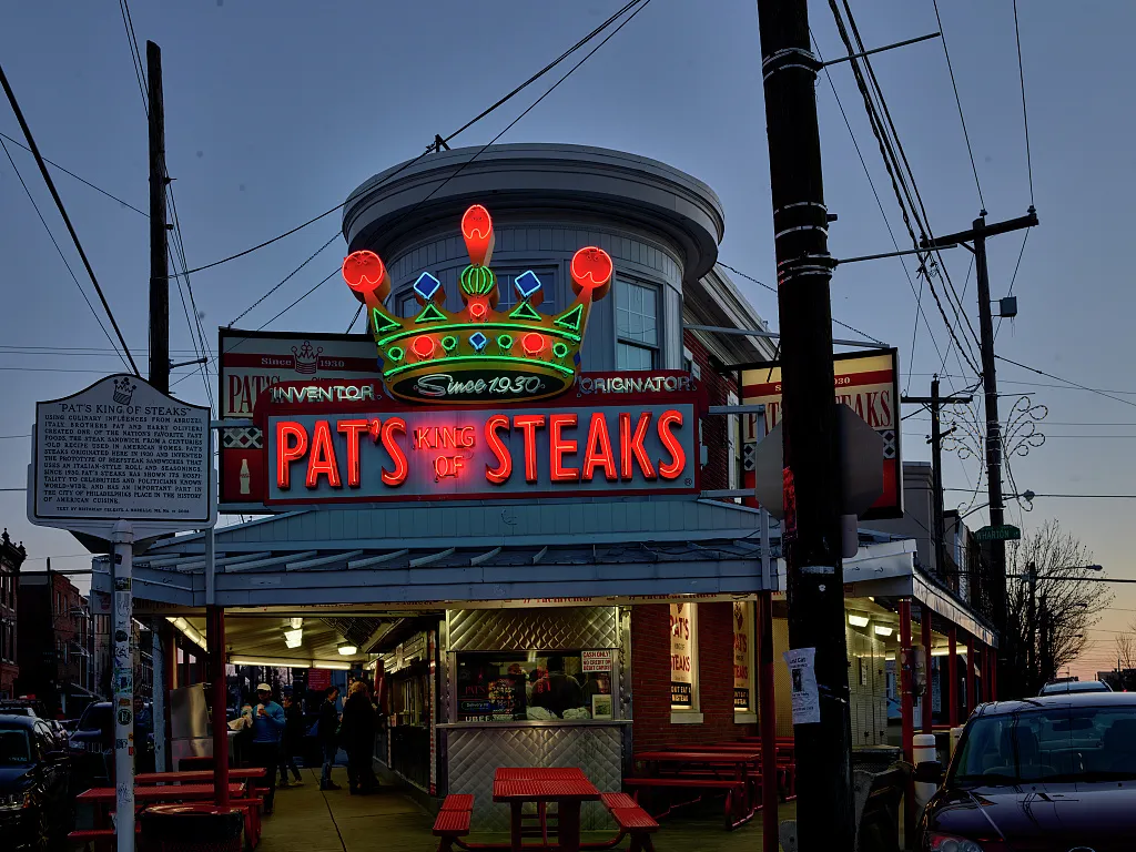 A 2019 photograph of Pat's King of Steaks, with the historical marker visible at left