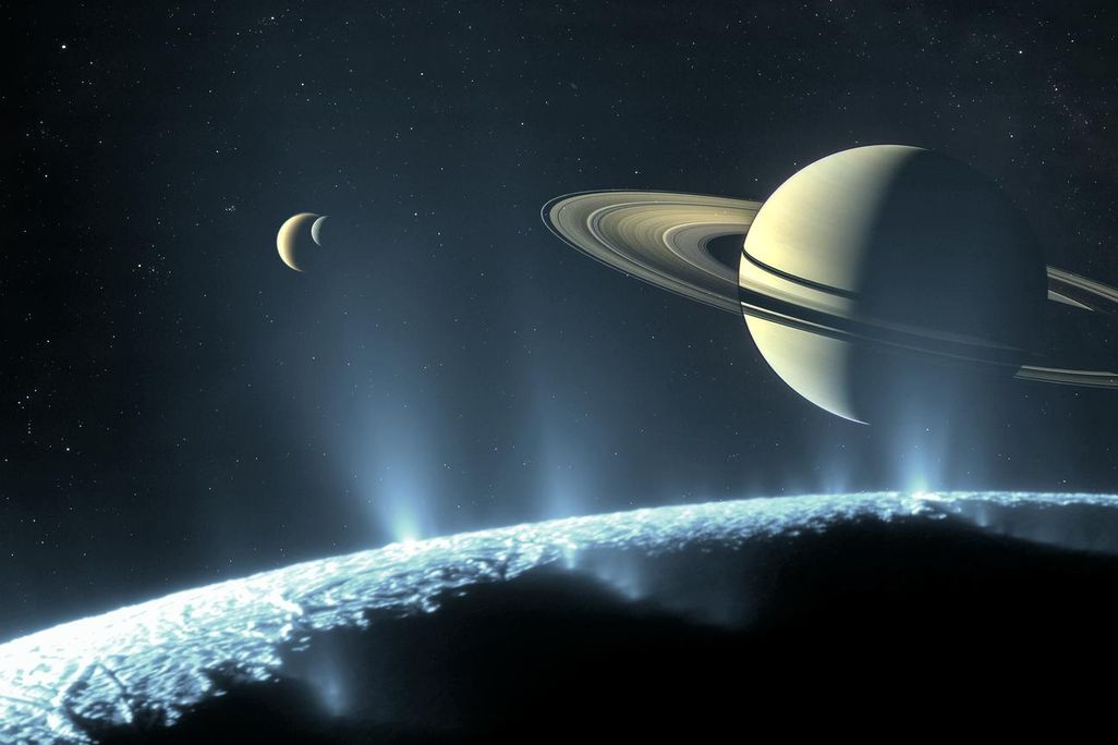 saturn and a moon in the distance seen over the horizon of an icy moon with geysers
