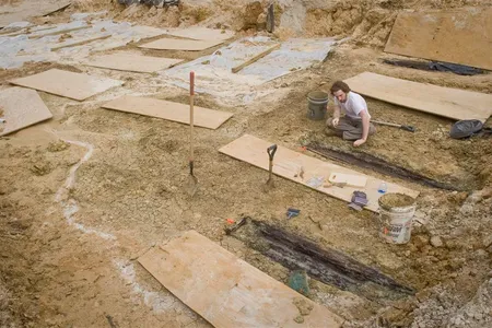 A researchers examines some of the graves unearthed in 2013