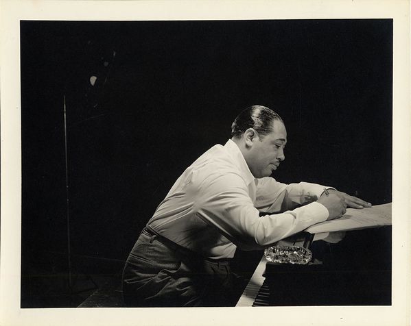 [Duke Ellington composing at the piano], 1928. Valentino Sarra. Duke Ellington Collection. Archives Center, National Museum of American History, Smithsonian Institution. </p> <p> <b>Duke Ellington b. April 1899 – d. May 1974 </b><br /> The Duke was the iconic composer, bandleader, and pianist whose five-decade career guided the birth and art of big-band jazz, made him one of the greatest composers in history, gave the Harlem Renaissance and modernity a soundtrack, and told the story of his people in musical tales like 
