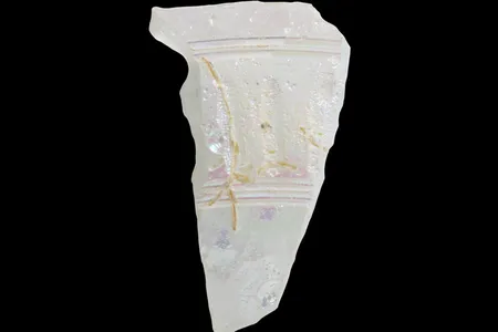 A clear shard of Roman glass found in northern Jordan. The purple highlights are iridescence caused by weathering.

