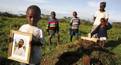 Jokim Githuka, 3, displays a portrait of his dead father, Robert Njoya, in a Kenyan maize field. Other sons stand by his grave with Njoya's widow, Serah. The trial of his undisputed killer, Thomas Cholmondely, has electrified this former British colony.