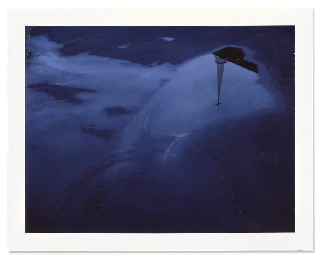 The steeple of the Oak Mountain Baptist Church is reflected in a rain puddle.