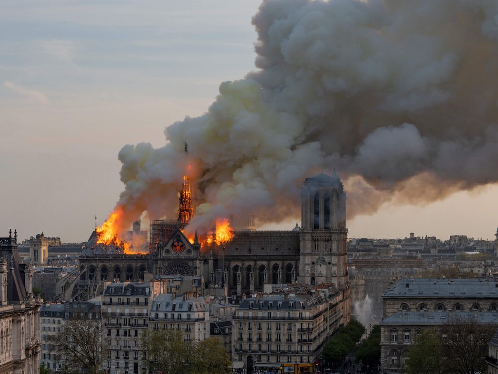 A thick cloud of smoke floats up from the Notre-Dame Cathedral as it burns, on April 15, 2019