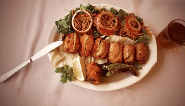 middle eastern-style grilled chicken kabob plate local restaurant. thumbnail