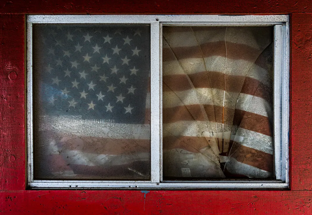 6 - An American flag is visible through a broken window pane in San Francisco.