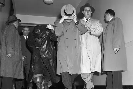 MAFBI agents (right) escort Vincent James Costa (center) and Michael Vincent Geegan (left) from Federal Court 1/12. The two men together with four others were arrainged before UC commissioner for the $1,219,000 Brinks robbery on January 17,1950.