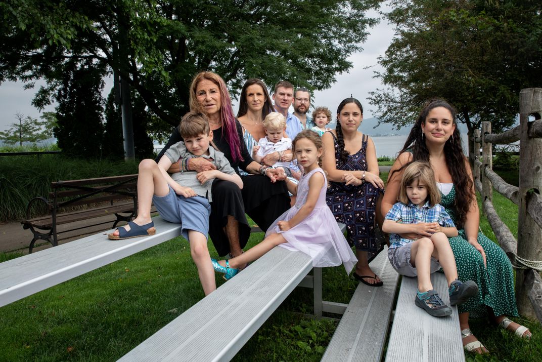 A family portrait on bleachers in a park