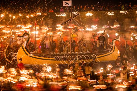 A finely crafted galley ship, with a dragon's head, is built and burned every year.