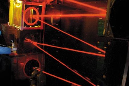 An engineer adjusts the beam-control optics that ride in the nose of the Airborne Laser Testbed, a modified Boeing 747-400F. The optics stabilize and shape the weapon laser’s beam as it is aimed by the nose turret’s computer-controlled telescope at a target missile.