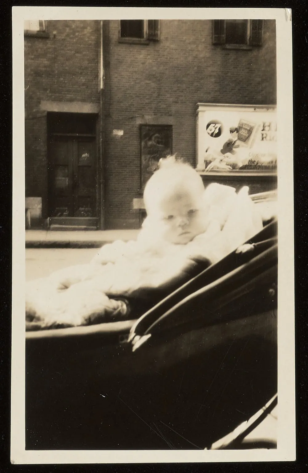 Roger Courtney’s infant son, Horace Sears Courtney, sits in a stroller.