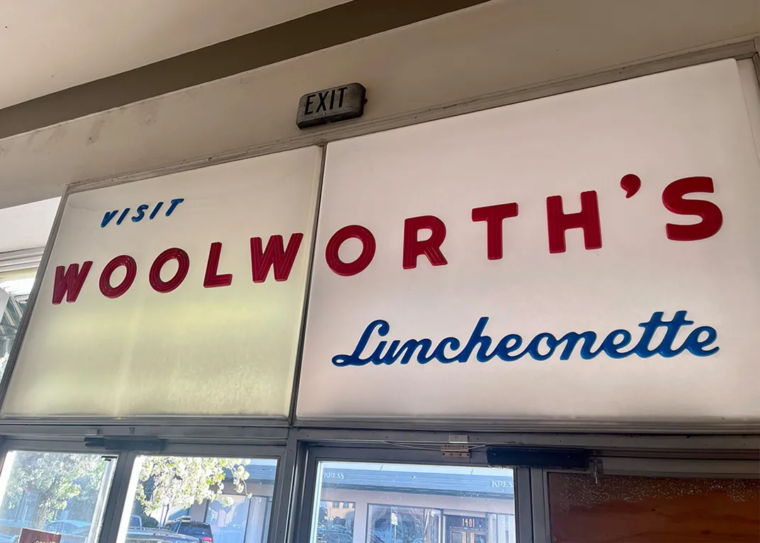 a vintage Woolworth's luncheonette sign above doors