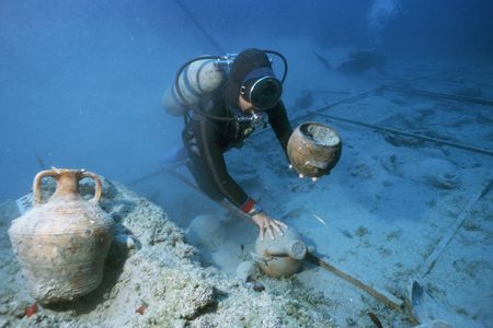 A diver sorts through the remains of a ship that sank in 1025 A.D. off the coast of Turkey. Though this site is out of the line of most cyclonic activity, similar sunken ships may contain a trove of information for climate scientists.