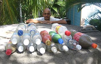 Soda bottles make up the bulk of the construction of a 3,500-liter cistern that Andreas Froese (pictured) and schoolchildren built in Roatan, Honduras. When filled with sand, the bottles become nearly indestructible.