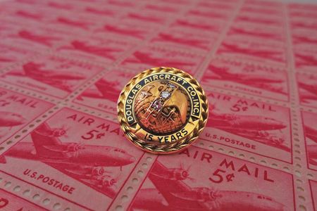Each pin is a miniature work of art, bearing the brand logo and rich with symbolism in engraved detail.