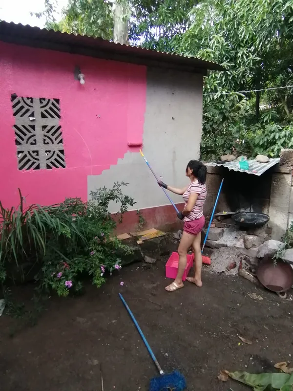 Nicaraguan woman painting her home thumbnail