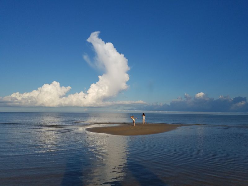 Island girls, while walking the shoreline on Waveland beach in Waveland