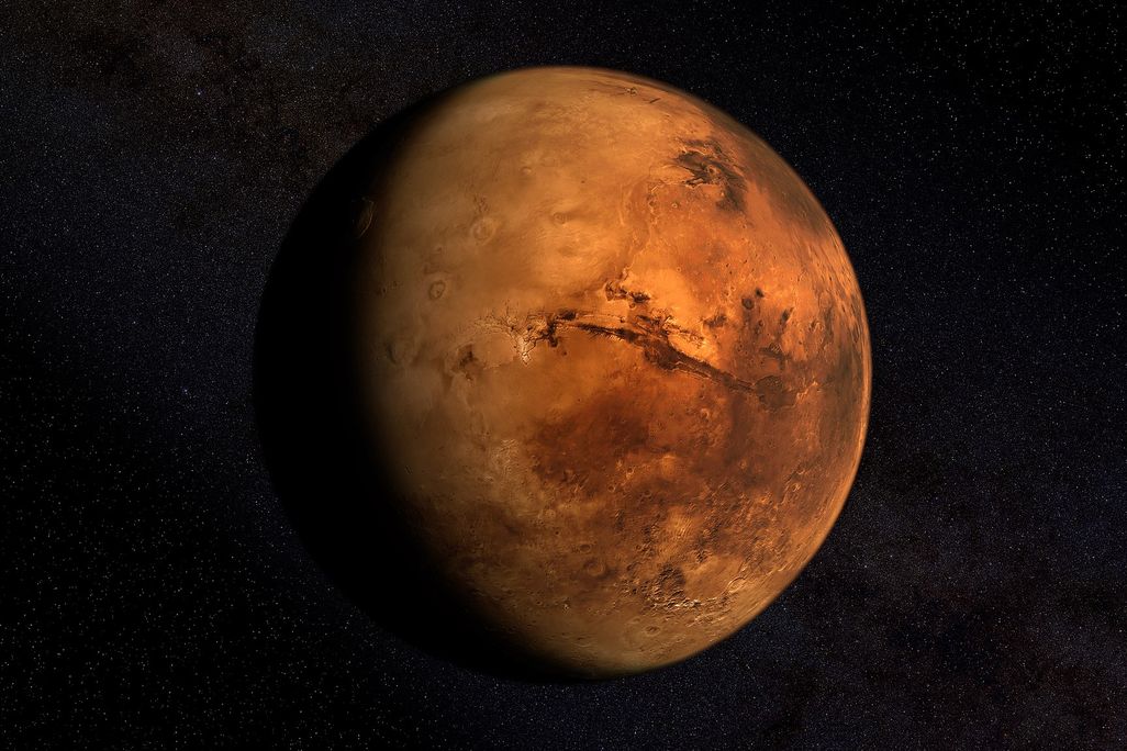 An image of Mars, shadowed on the right side