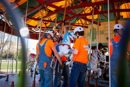 Workers install a horse in the refurbished Smithsonian carousel