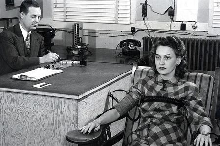 A man administers a security screening at the Clinton Engineer Works, part of the Manhattan Project.