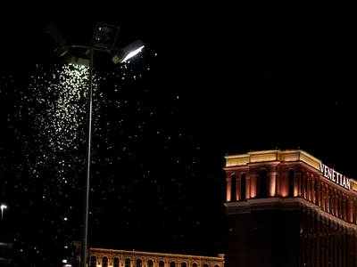 Grasshoppers swarm a light a few blocks off the Strip on July 26, 2019 in Las Vegas, Nevada. 