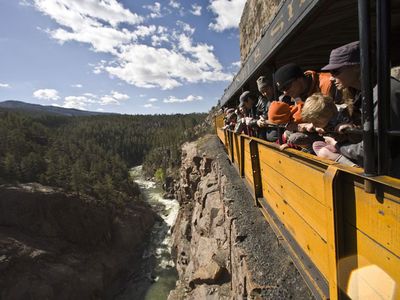 The narrow-gauge Durango & Silverton train steams through history above the Animas River.