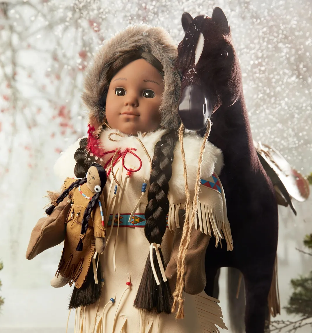 Kaya doll poses with her horse in front of a snowy backdrop