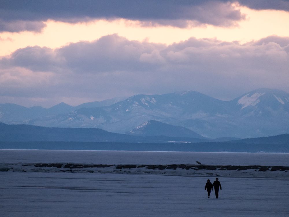 Two people walking on lake champlain
