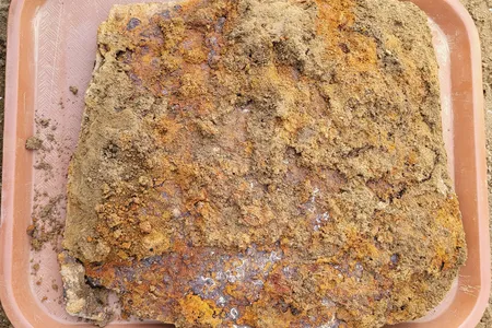 The metal slab is called a tasset, a piece of armor worn over the upper thigh.