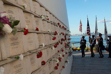 On the inner wall of one of the two "wings" comprising Masayuki Sono's Postcards monument in Staten Island, flowers are placed next to the names of victims of the 9/11 attacks. 