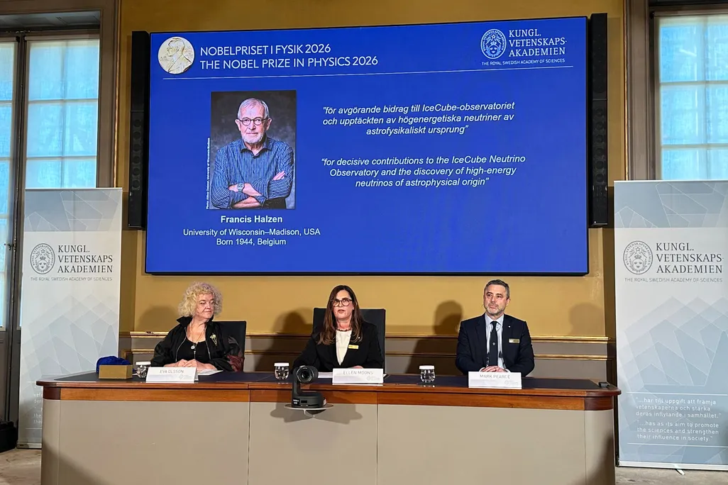 Onscreen headshot of Francis Halzen with three panelists sitting below the screen