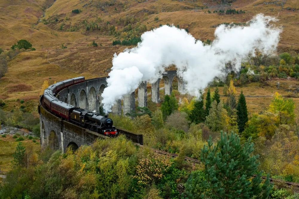 While I was on a photo tour of Scotland, the Harry Potter train was a must-see. It was the fall, and one of the last weekends the train was running for the season. Given that it only travels once or twice a day, we had to time it perfectly.

The train was made famous as the Hogwarts Express in the Harry Potter movies. As such, the side of the hill that we were standing on was full of people in Harry Potter paraphernalia.