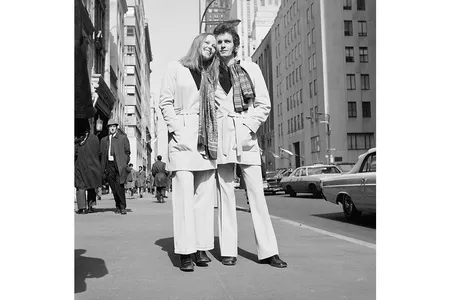 Swedish designer Sighten Harrgard and his fiancee model a unisex belted jacket and scarf with wide-legged double-knit trousers—March 1969.