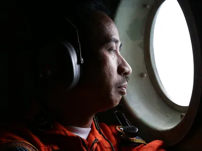 An Indonesian Air Force troops looks for AirAsia flight QZ8501 in the Karimata Strait.