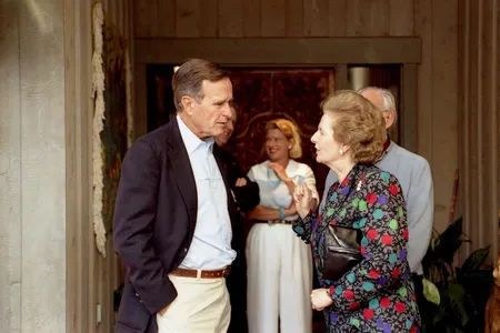 Thatcher visits with President Bush in Aspen, Colorado in 1990 during a diplomatic reception. News of her resignation lit up diplomatic channels around the world. 