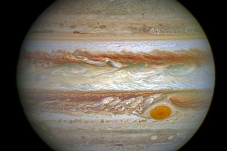 Ultraviolet images overlying a photo of Jupiter taken by the Hubble Space Telescope