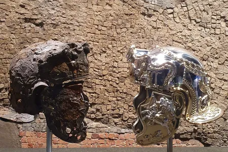 The first-century C.E. helmet alongside a newly created replica