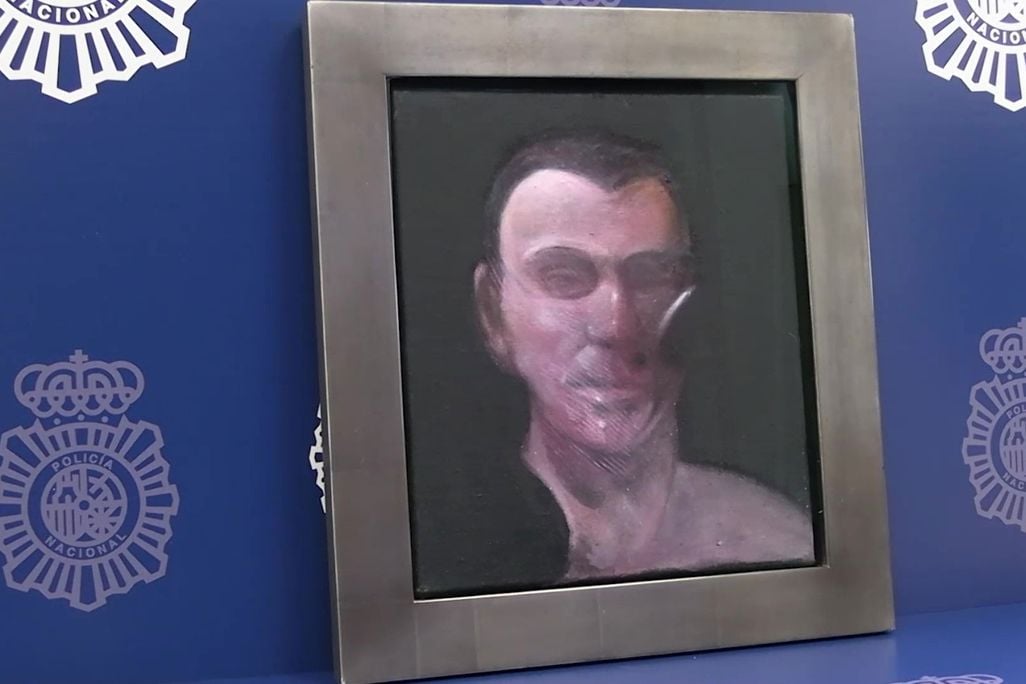 Frame painting of a man's face against a blue background