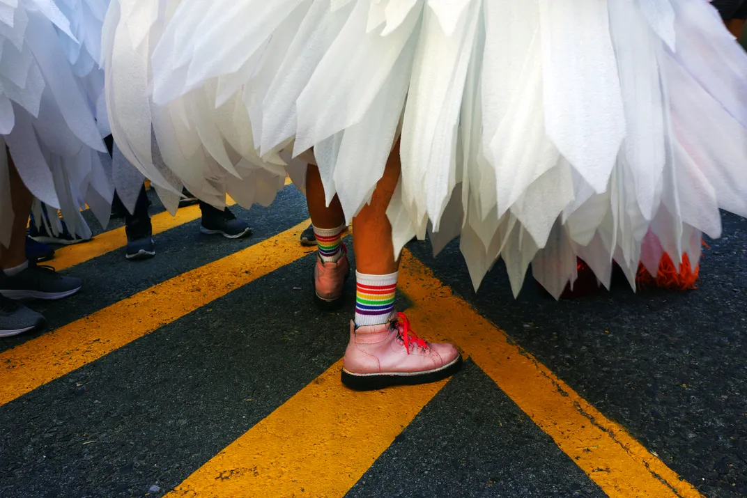a pink shoe with rainbow sox