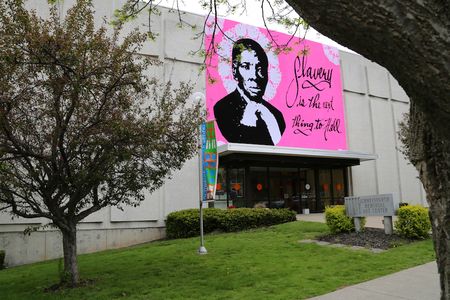 Measuring 32 feet in size, the massive "yarn bomb" of Harriet Tubman now hangs outside the Schweinfurth Art Center in Auburn, New York.