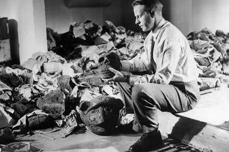 Thor Heyerdahl photographed with archaeological artifacts from Easter Island